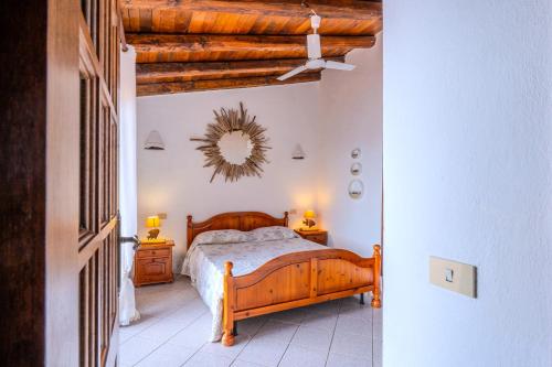 a bedroom with a bed and a mirror on the wall at Casa Paradiso Guest House in Costa Paradiso