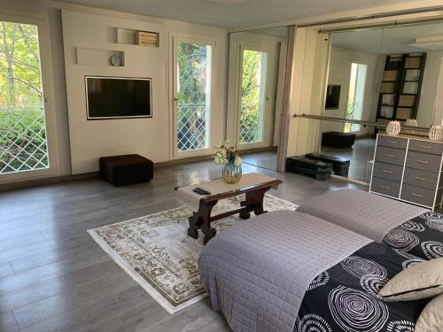 a bedroom with a bed and a table and a tv at La tua casa con giardino a 2 passi dal centro in Modena