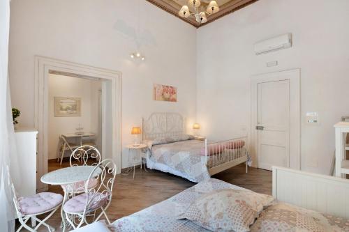 a bedroom with a bed and a table and chairs at Aparthotel in pieno centro storico in Naples