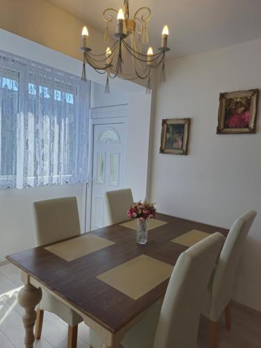 a dining room table with chairs and a vase of flowers at Apartment Elizabeth in Split