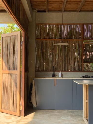 a kitchen with a counter with a sink and a door at Serenity Home in San Bernardo del Viento