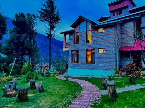 a house with a brick path in front of it at 4 Bedroom Luxury Bungalow In Manali With Beautiful Scenic Mountain & Orchard View - #Private Bungalow #Premium Big rooms #Parking #Guest Preferred in Manāli