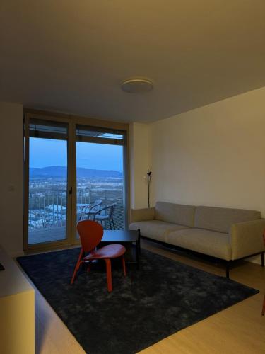 a living room with a couch and a chair at Apartmán Grand in Prešov
