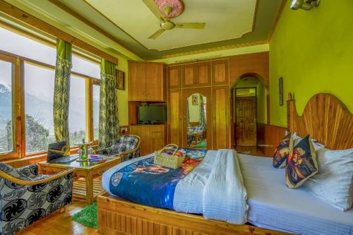a bedroom with a bed and a table and some windows at 4 Bedroom Luxury Bungalow In Manali With Beautiful Scenic Mountain & Orchard View - #Private Bungalow #Premium Big rooms #Parking #Guest Preferred in Manāli