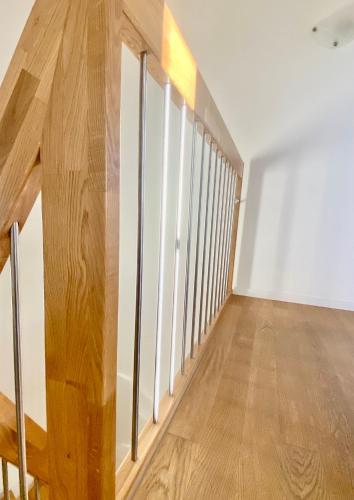 an empty room with white walls and wood floors at Grosse Wohnung mit Sauna in Huttwil