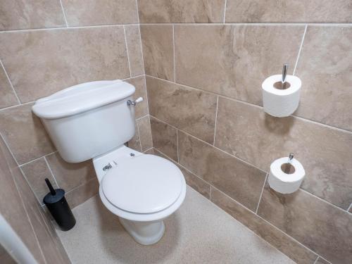 a bathroom with a toilet and two rolls of toilet paper at The Black Boy Inn in Caernarfon