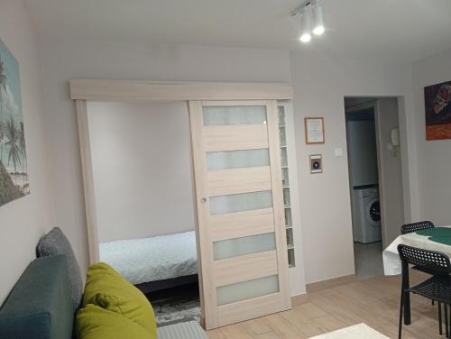 a room with a sliding door leading to a bedroom at Apartament Zacisze in Częstochowa