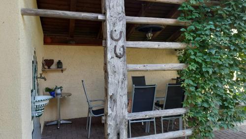 a wooden ladder with chairs and a table in a building at Ferienwohnungen Berger in Kötschach