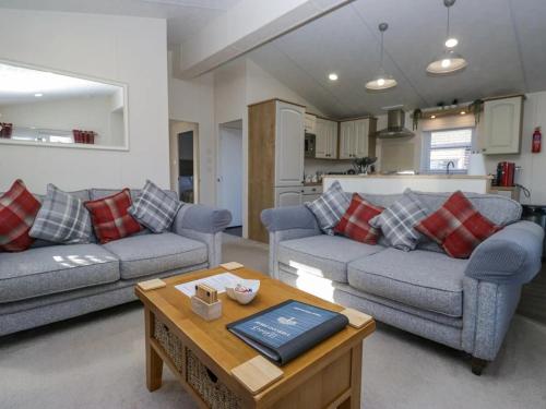 a living room with two couches and a table at Lakeland Dream in Warton