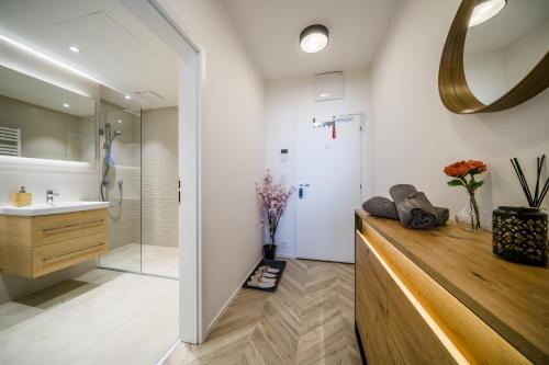 a bathroom with a sink and a shower at APARTIA apt Brno center in Brno