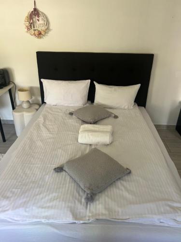 a large white bed with two towels on it at Apartament Stara Piekarnia in Tychy