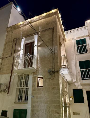 a building with two balconies on the side of it at Iris Apartments in Monopoli