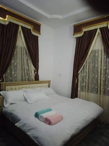 a bedroom with a bed with a towel on it at Stylishly in Rubuchi