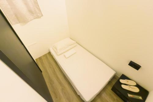 Ένα ή περισσότερα κρεβάτια σε δωμάτιο στο BLANC INN Singapore