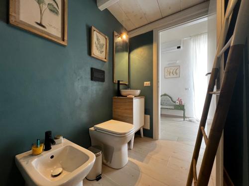 a bathroom with a white toilet and a sink at La Cupoletta Ponza in Arcipelago Ponziano