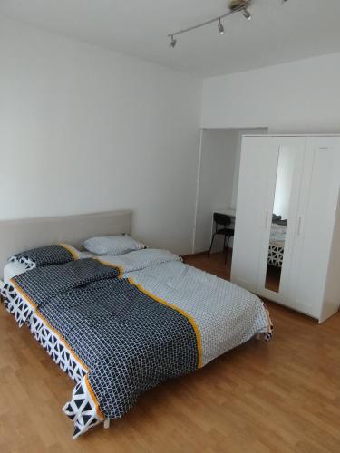 a bedroom with a bed with two pillows on it at Belle maison in Aalst