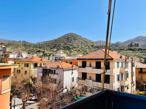 a view of a city with houses and mountains at Sottovento Central Apartment in Levanto