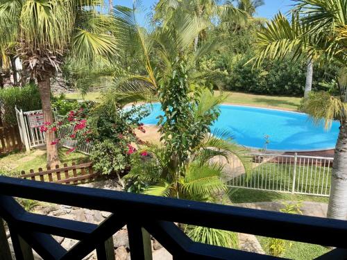 a view from the balcony of a resort with a swimming pool at Le Sable Blanc - piscine - parking - clim - wifi in Saint-Gilles-les-Bains
