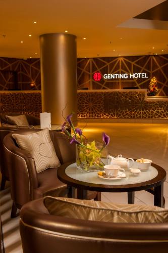 a coffee table with flowers on it in a hotel lobby at Genting Hotel & Spa at Resorts World Birmingham in Bickenhill