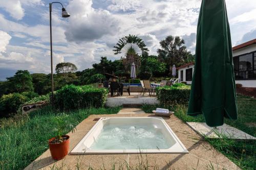a hot tub sitting in the middle of a yard at FINCA CON VISTA DESLUMBRANTE - Rinconada, descanso total in Apulo
