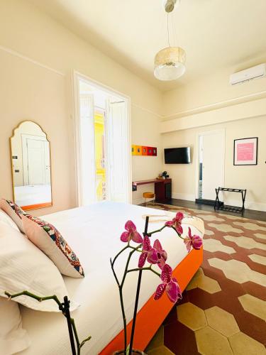 a bedroom with a bed with a flower on it at Voglia 'e turnà in Naples