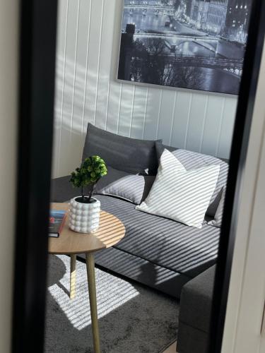 a living room with a couch and a table at Kaldvell Stays Central - New Apartment in Lillesand