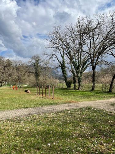 a park with trees and a path in the grass at Bran & Denise Residence in Costermano sul Garda