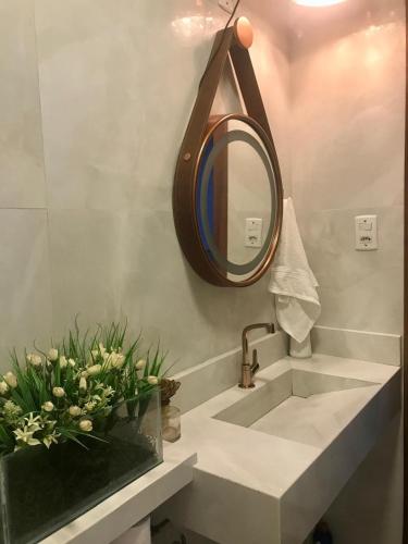a bathroom with a sink and a mirror at Large and comfortable house in Belém