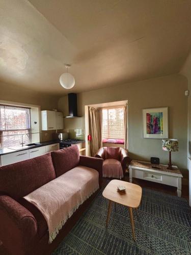a living room with a couch and a table at Princeland Lodge in Blairgowrie