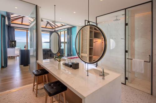a bathroom with a sink and a mirror at Premier Village Phu Quoc Resort Managed by Accor in Phu Quoc