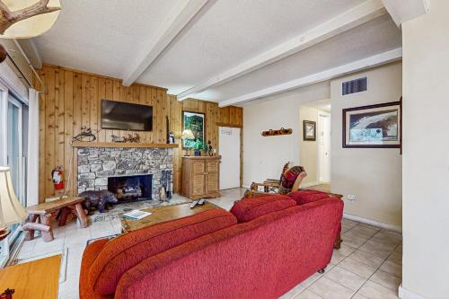 a living room with a red couch and a fireplace at Bee Branch 04 in Sugar Mountain