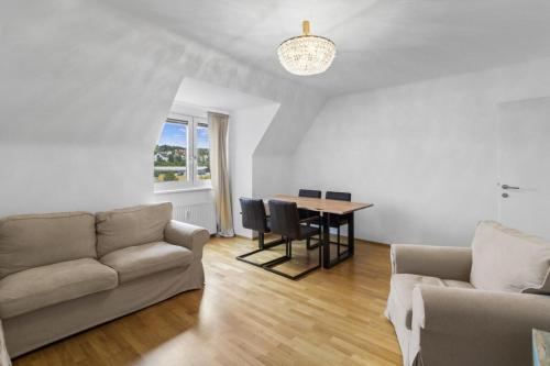 a living room with a couch and a table at Golden Stay Residence in Brunn am Gebirge