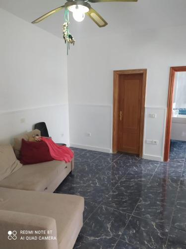 a living room with a couch and a ceiling fan at Claudia - Gortito in Playa Paraiso
