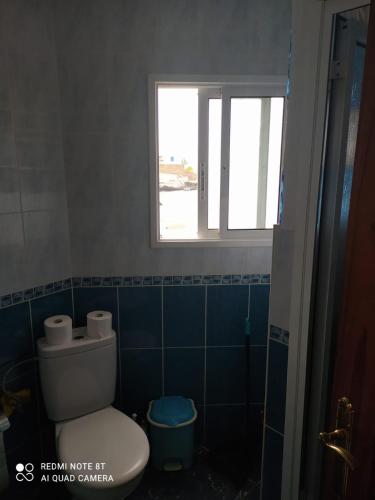 a bathroom with a toilet and a window at Claudia - Gortito in Playa Paraiso