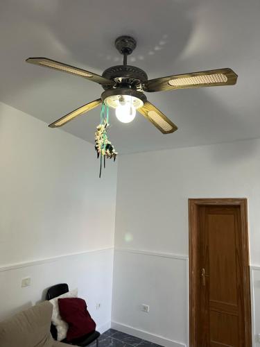 a ceiling fan in a living room with a couch at Claudia - Gortito in Playa Paraiso
