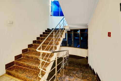 a staircase in a building with a metal railing at Townhouse Hatigaon Near Medicity Formerly Hotel Grand Majesty in Guwahati