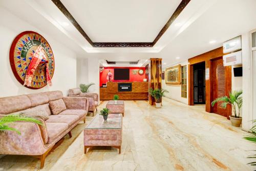 a living room with a couch and a table at Townhouse Hatigaon Near Medicity Formerly Hotel Grand Majesty in Guwahati