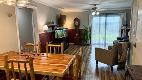 a living room with a wooden table and a television at Ferris view horizon in Branson