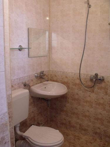 a bathroom with a toilet and a sink at Стаи за гости" Герови" in Nesebar