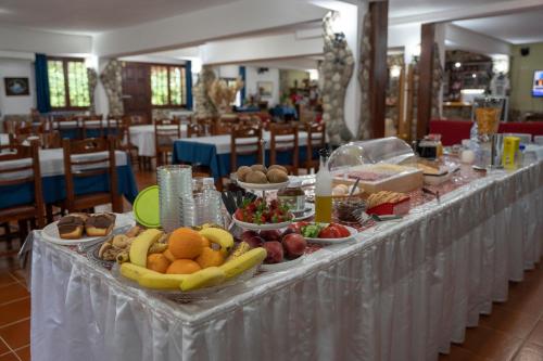 a buffet table with fruits and other food on it at Pineas in Kalabaka