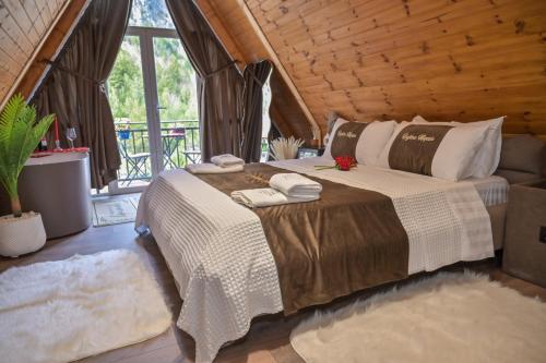 a bedroom with a bed with two towels on it at Bujtina Miqesia in Theth