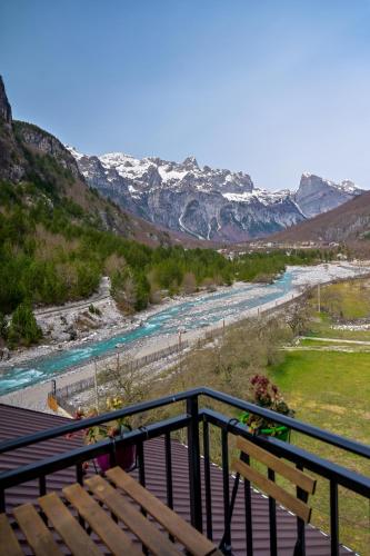 a view of a river with snow capped mountains at Bujtina Miqesia in Theth