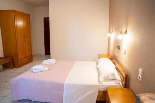 a bedroom with a bed with two towels on it at Pineas in Kalabaka