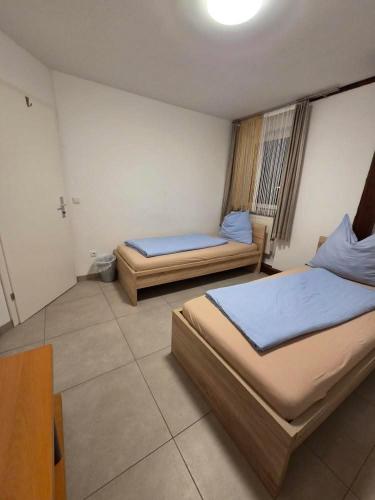 a room with two beds and a table in it at Gästezimmer Schwanenstadt in Schwanenstadt