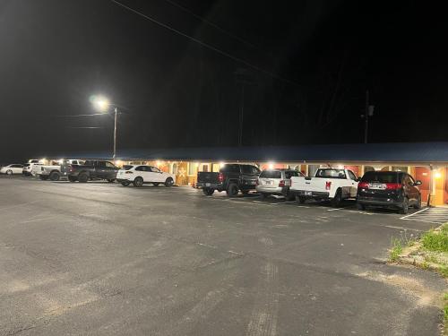 a group of cars parked in a parking lot at night at Scottis inns in Hurricane Mills