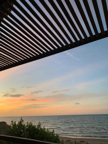 a view of the ocean from the beach at sunset at Serenity Home in San Bernardo del Viento