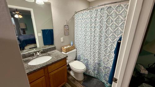 a bathroom with a toilet and a sink and a mirror at Ferris view horizon in Branson