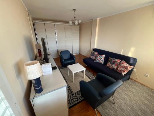 a living room with a couch and a chair at Comfort & Style Panoramic Urban Retreat 2 in Belgrade