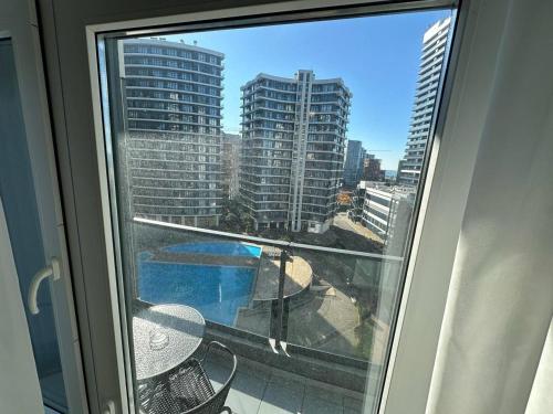 a balcony with a view of a city with tall buildings at Luxury Suites White Sails in Batumi
