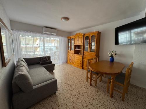 a living room with a couch and a table at La Turia Soleada in Cullera